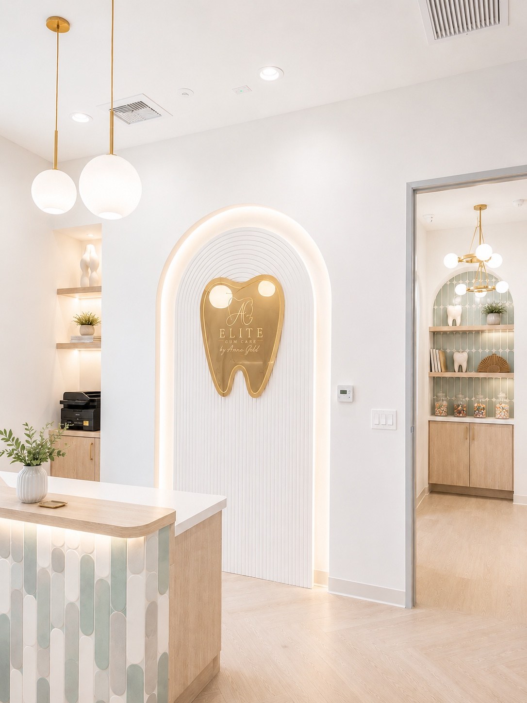 Elite Gum Care reception with gold tooth logo and illuminated arch